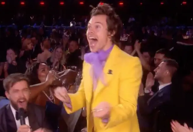 Harry Styles celebrates as Lizzo chugs a glass of tequila on the BRITs