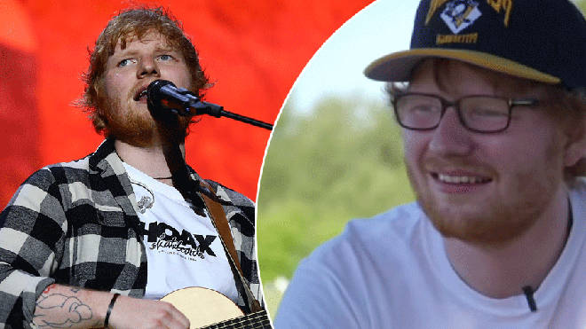 Ed Sheeran singing and playing guitar on stage