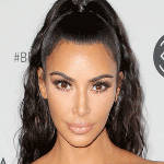 Kim Kardashian poses in black crop top
