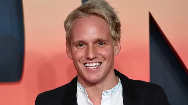 Jamie Laing poses on the red carpet in black blazer