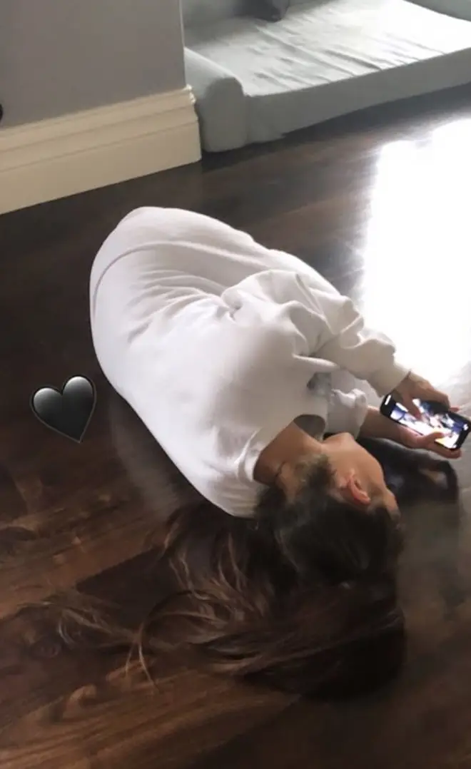 Ariana Grande lying on the floor of her LA mansion