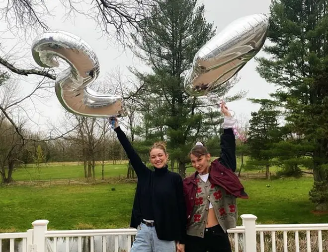 Gigi and Bella Hadid pose with birthday 'gender reveal' balloons