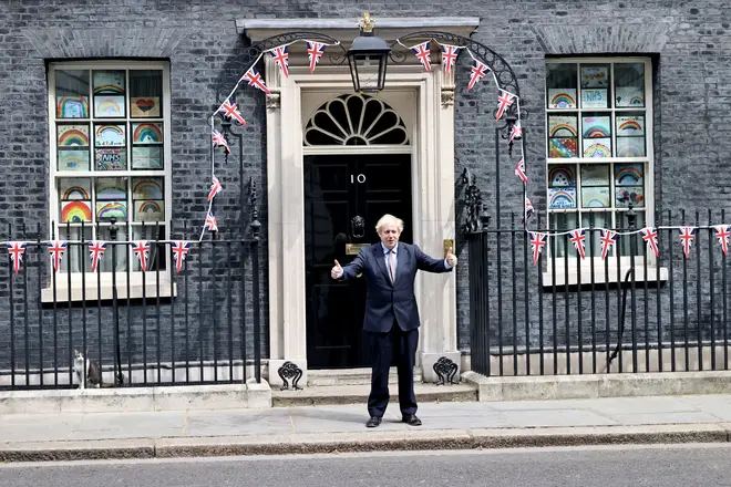 Prime Minister Boris Johnson stands outside 10 Downing Street on Friday as the UK commemorates the 75th Anniversary of Victory in Europe Day (VE Day)