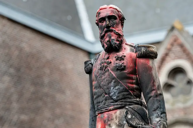 The statue of King Leopold II in Antwerp is defaced before being removed