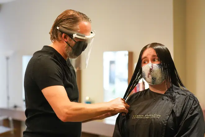 Customer and worker wear masks as hair salons Reopen In England