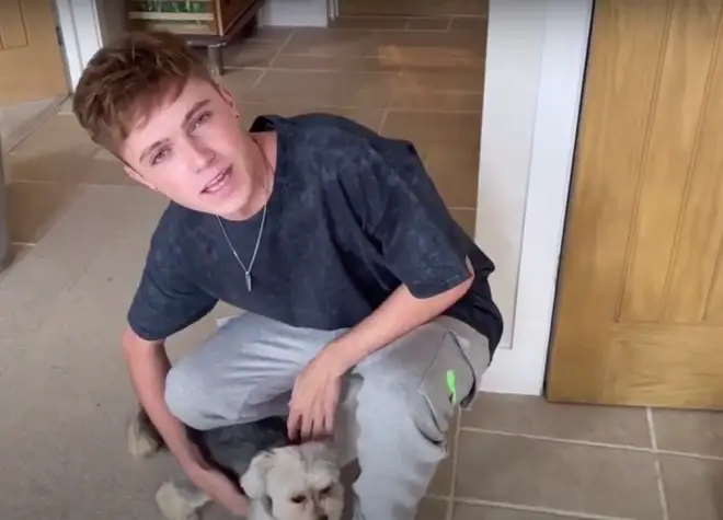 HRVY proudly shows off his family dog