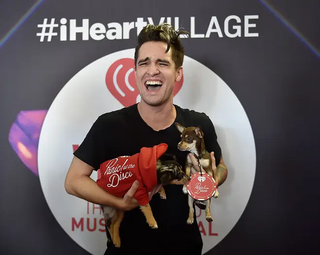Brendon Urie holding puppies