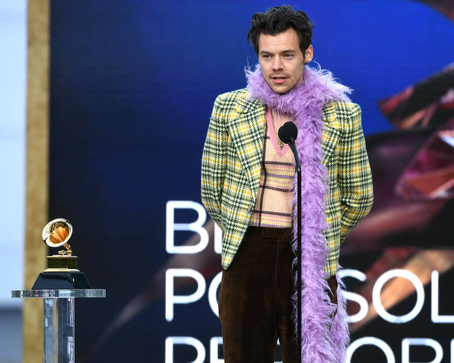 Harry Styles wore a purple feather boa with a yellow checkered outfit at the Grammys.