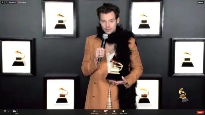 Harry Styles wore a feather boa with three outfits at the Grammys.