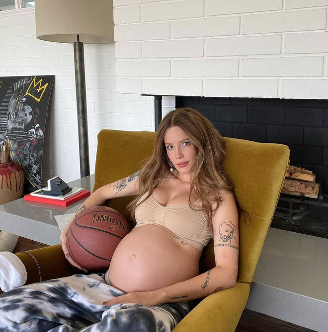 Halsey shared a side-by-side snap of her growing bump next to a basketball.