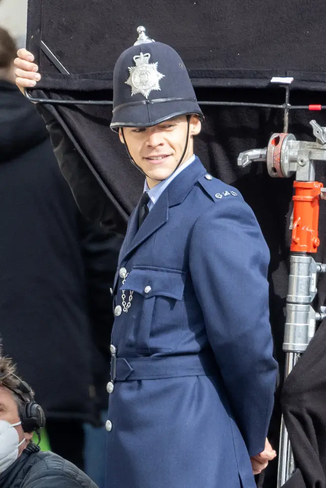 Harry Styles dressed as a policeman as he films in Brighton