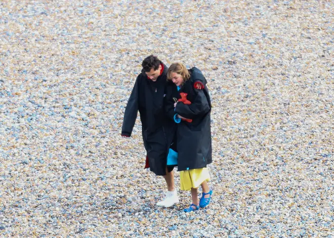 Harry Styles and his co-star Emma Corrin at Brighton as they film together.