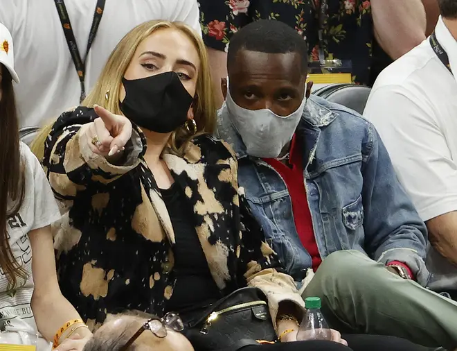 Singer Adele looks on next to Rich Paul