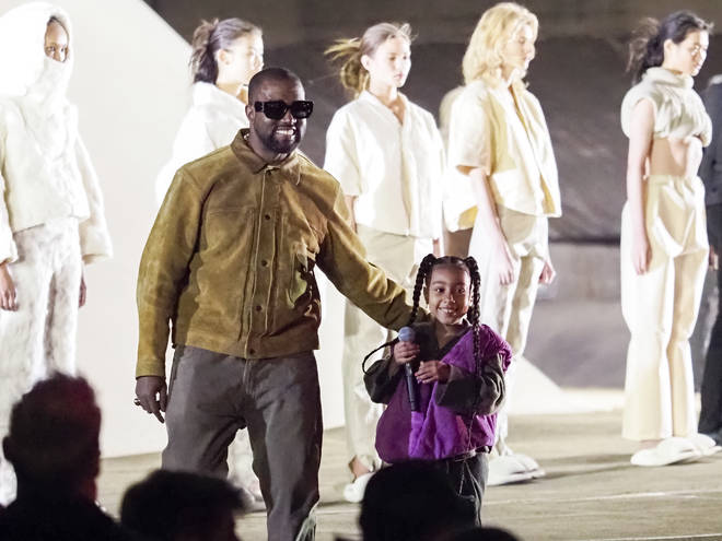 Kanye West and daughter North West at the Yeezy fashion show