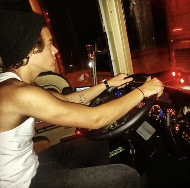 Harry Styles driving the One Direction tour bus