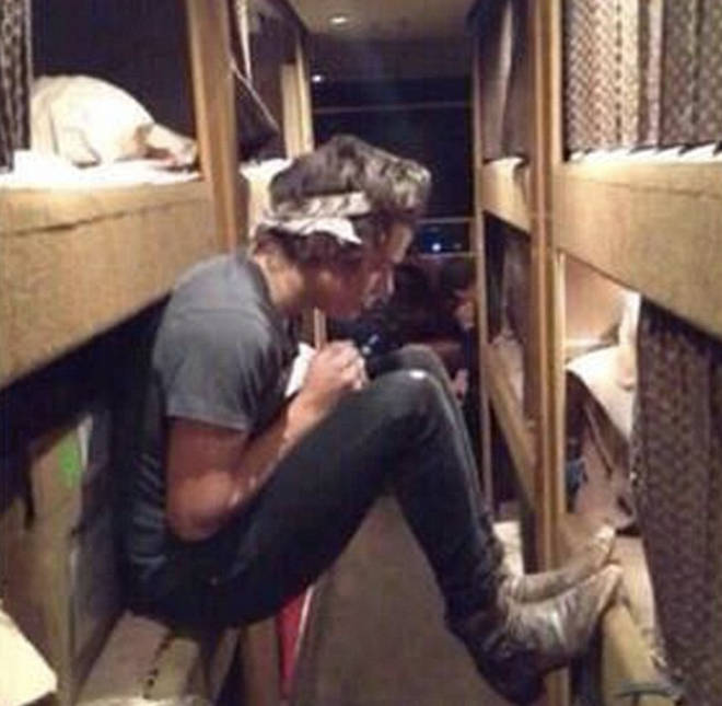 Harry Styles playing around on the 1D tour bus in 2012