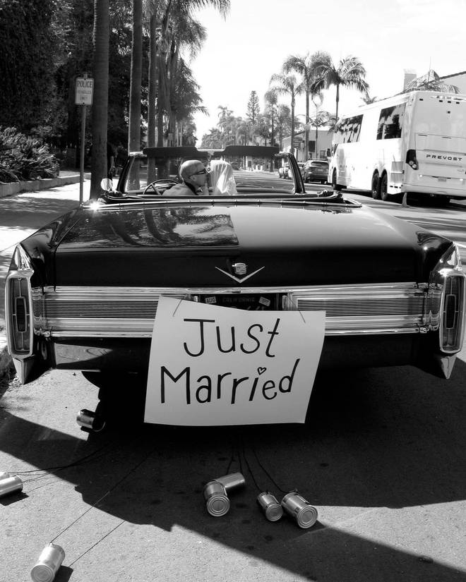 Travis and Kourtney left the wedding in a convertible that read 'Just Married'
