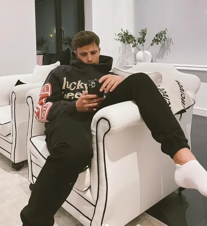 Love Island's Luca Bish sitting on his phone