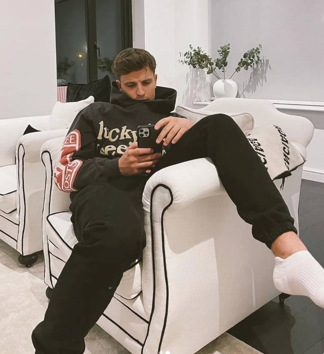 Love Island's Luca Bish sitting on his phone