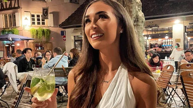 Lacey Edwards drinking in Paris wearing a white dress