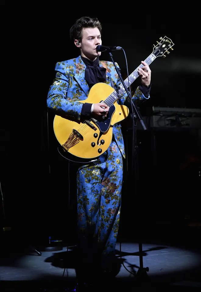 Harry Styles performs at the Greek Theatre in LA wearing vibrant blue suit