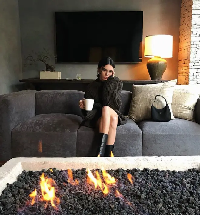 Kendall Jenner sits by her fire pit