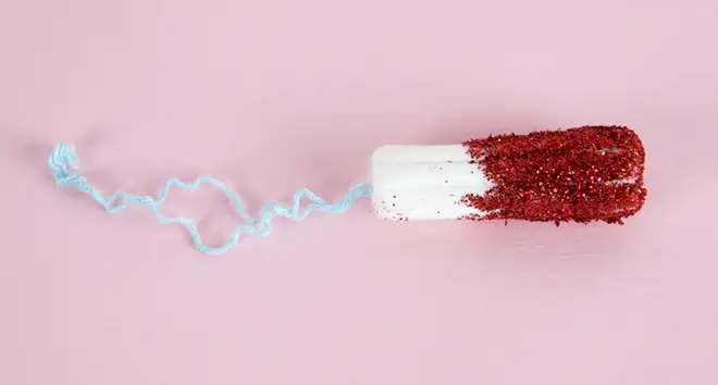 A hygienic tampon with red glitters instead of blood
