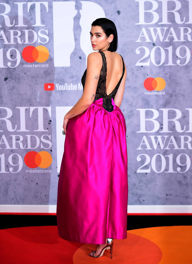 Dua Lipa rocks a backless gown on the BRITs red carpet