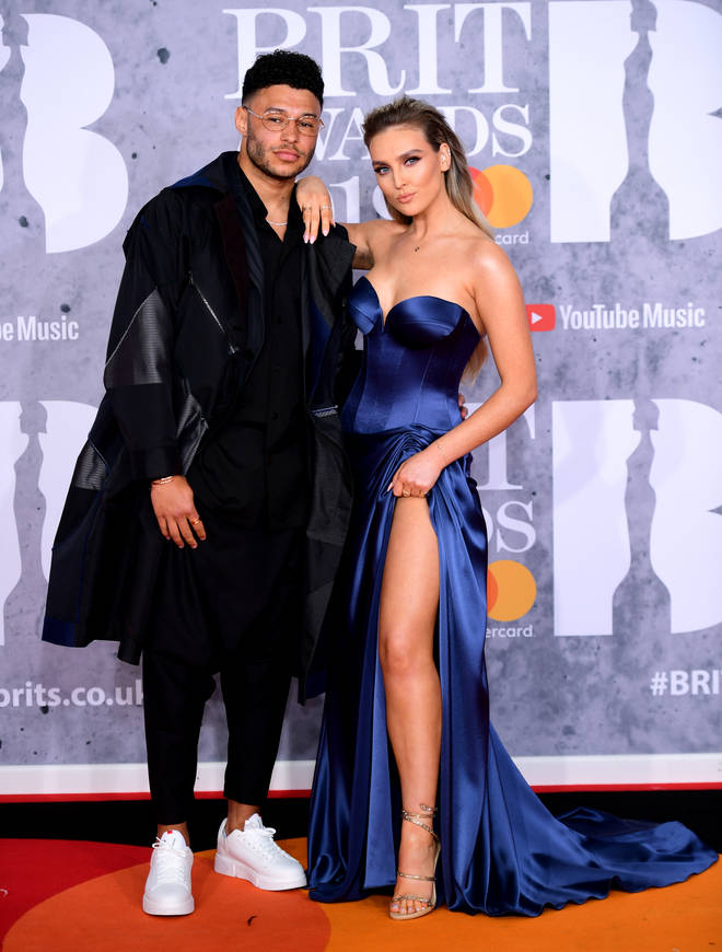 Perrie Edwards is joined by boyfriend Alex Oxlade-Chamberlain on the BRITs red carpet
