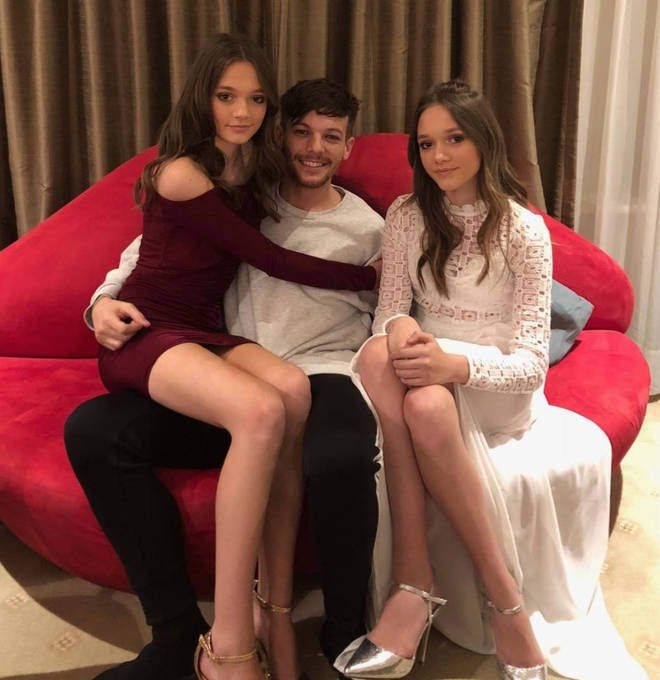 Louis posing with twins Phoebe and Daisy