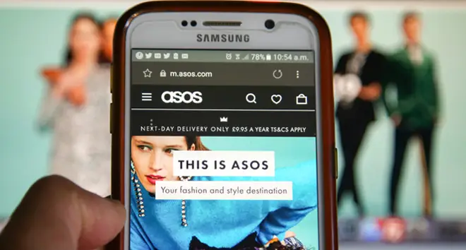 A woman is seen shopping on ASOS the online fashion store on a mobile phone.