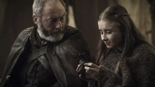 Shireen Baratheon and Ser Davos read about Jon Snow's lineage in a book about Aegon Targaryen