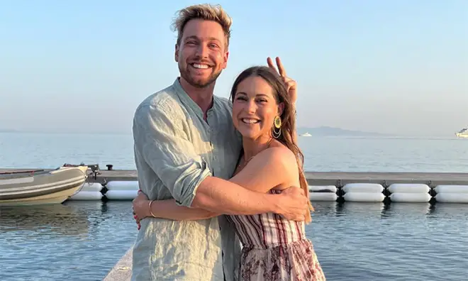 Sam Thompson and Louise posing on a beach