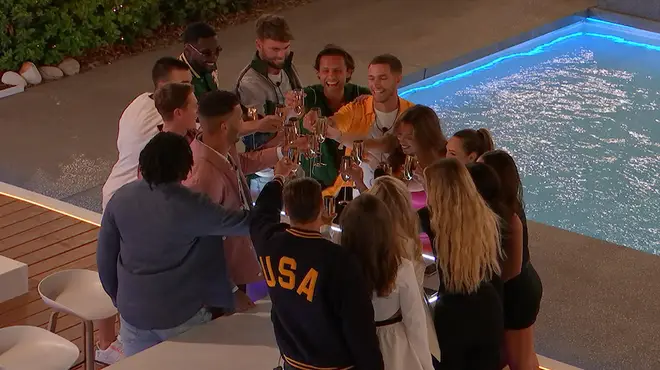 Love Island 2023 contestants raising a glass around the pool