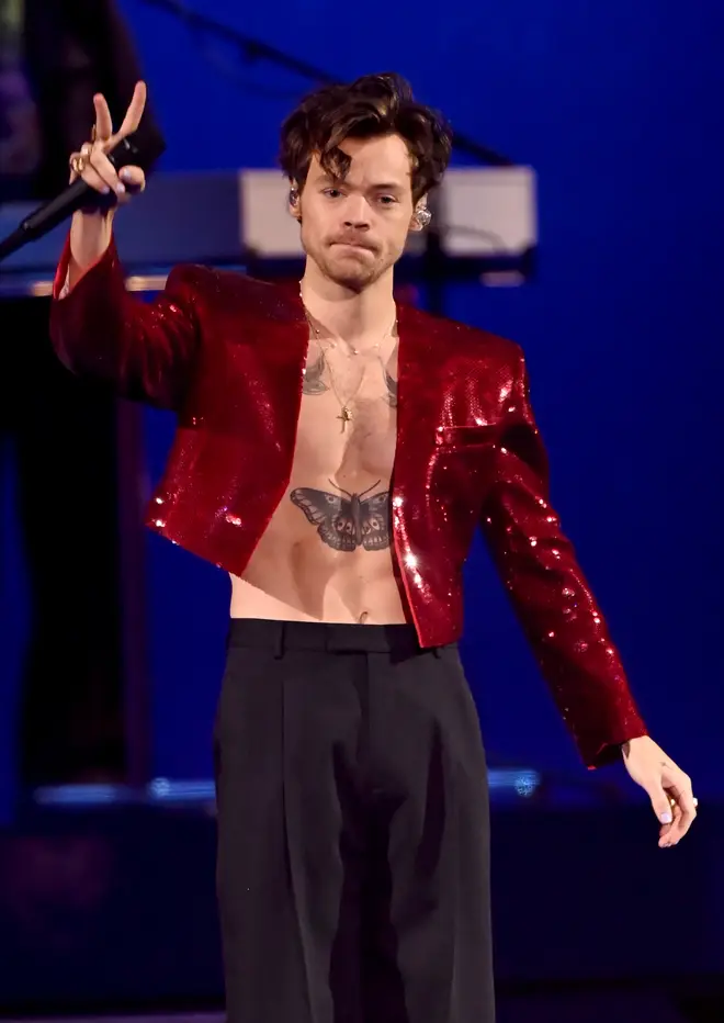 Harry Styles performing in red suit