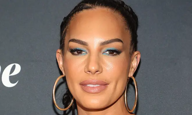 Amanza Smith wearing large gold hoops and blue eyeshadow