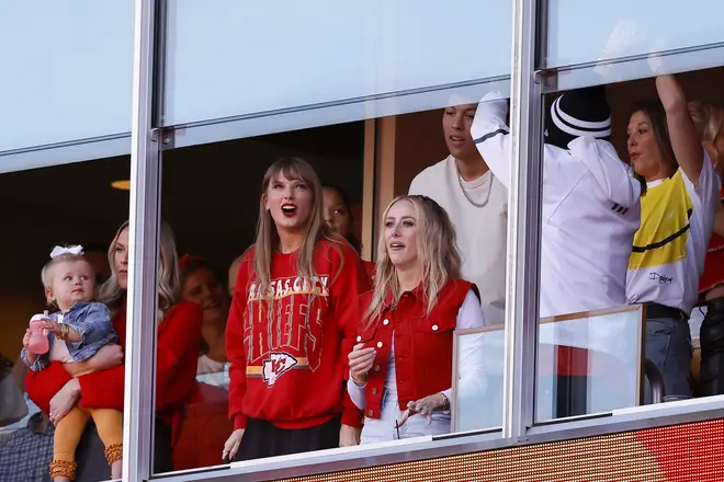 Taylor Swift and Brittany Mahomes reacting to a touchdown scored by Travis Kelce