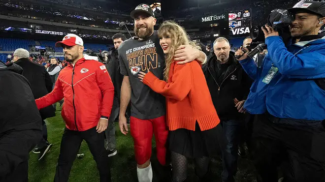 Taylor Swift and Travis Kelce hugging on the football field
