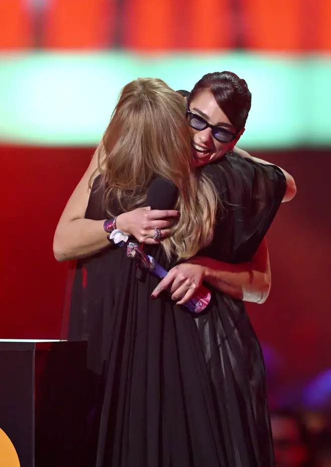 Kylie Minogue and Dua Lipa share a hug on The BRITs stage