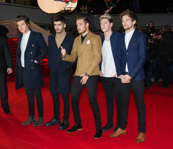 All five members of One Direction posing on the red carpet