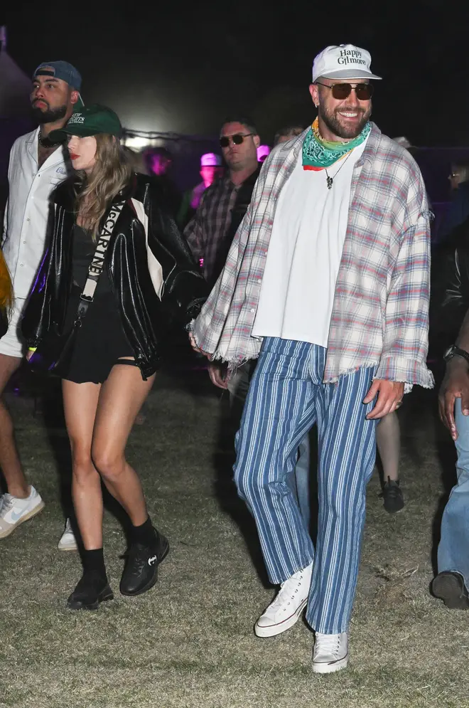 Taylor and Travis held hands as they enjoyed the festival