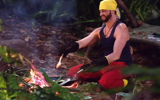 The I'm A Celeb campmates use the fire to cook the rice and beans